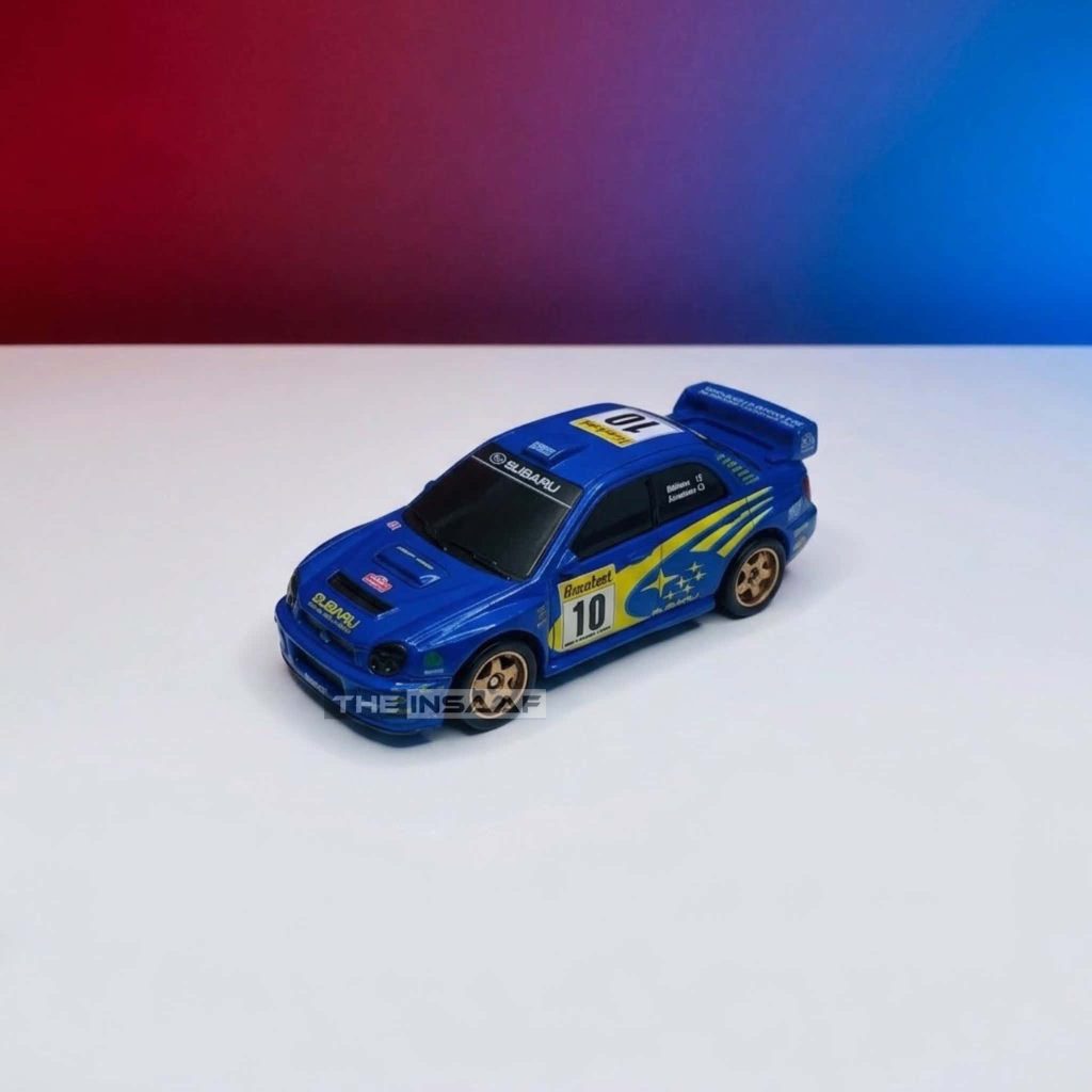 Blue miniature die-cast sports rally car toy on a dual-tone background